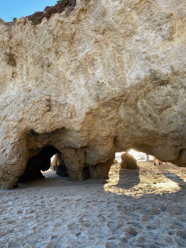 El Matador sea cave view with beach and sunlight peaking through.