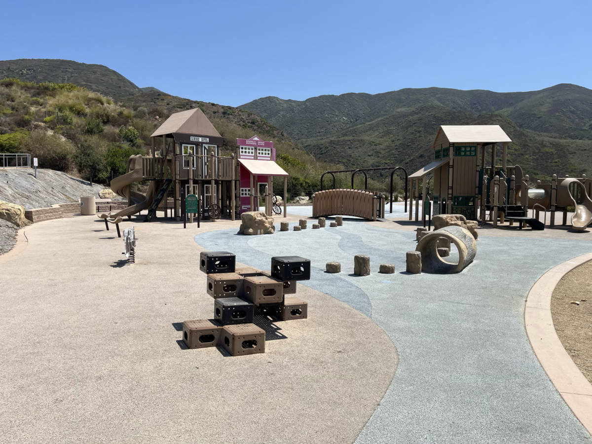 Tracas Canyon Playground climbing blocks, bridge and play structure with Malibu mountains in the background.