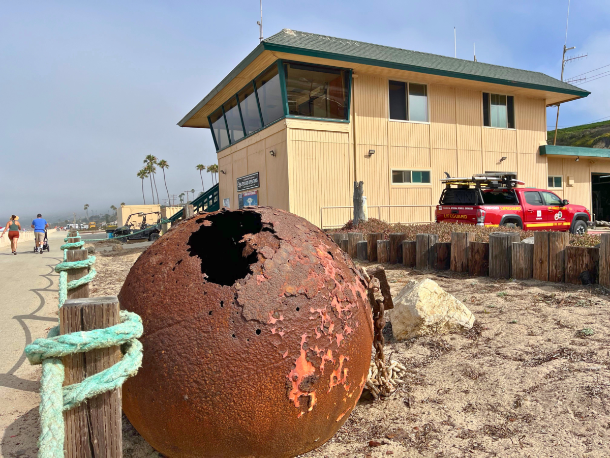 Zuma beach old beach buoy with a hole - rusted.