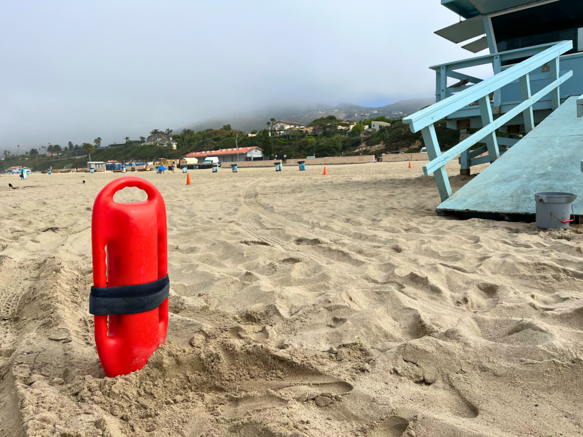 Zuma Beach lifeguard buoy anchored in the sand.