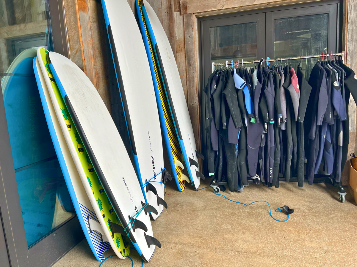 Drill Surf and Skate outdoor view with surfboards and wetsuits.